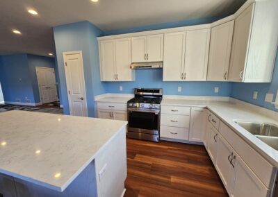A spacious kitchen with a large kitchen island and quartz countertops