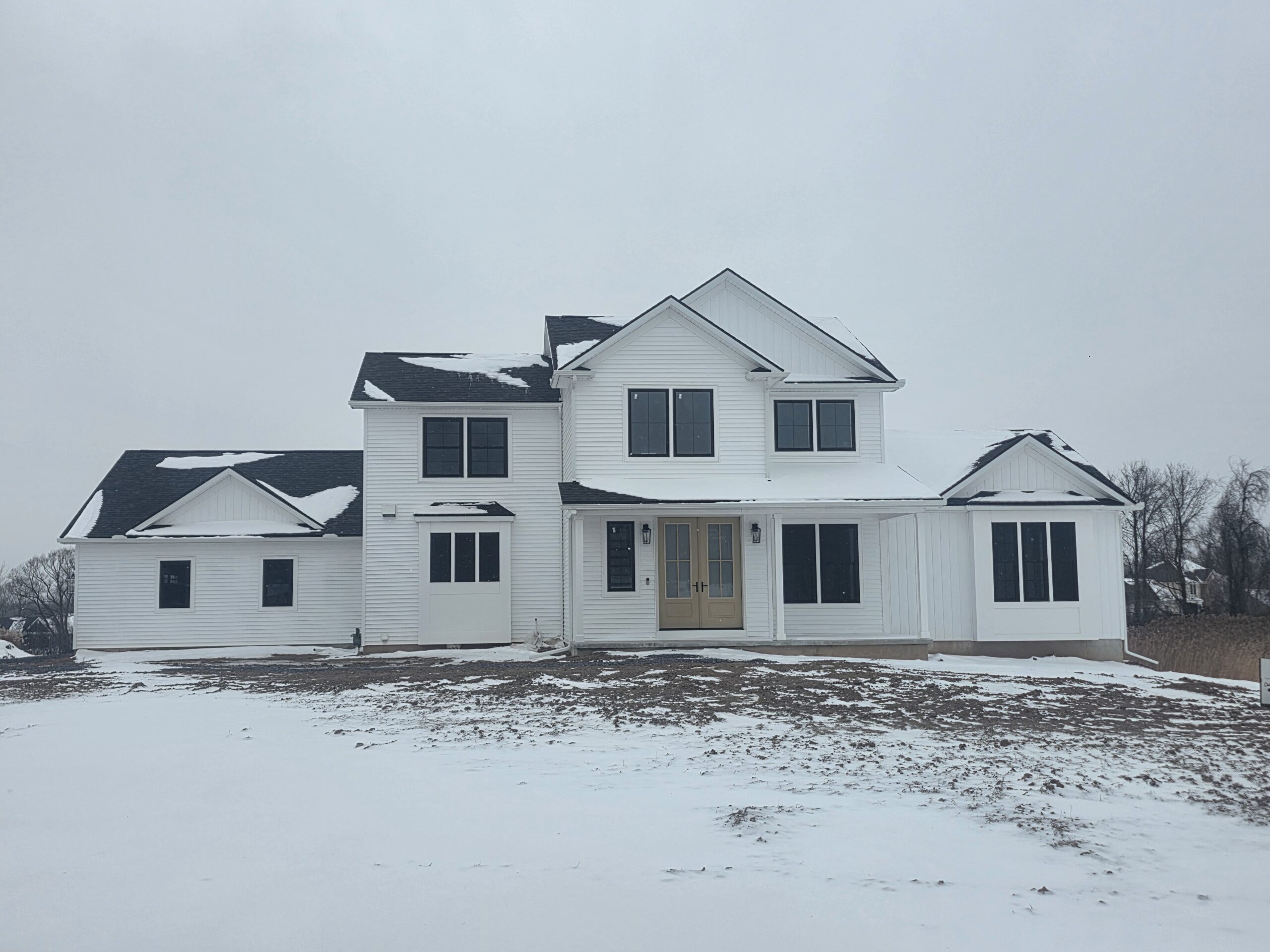 An exterior image of a home, covered in snow